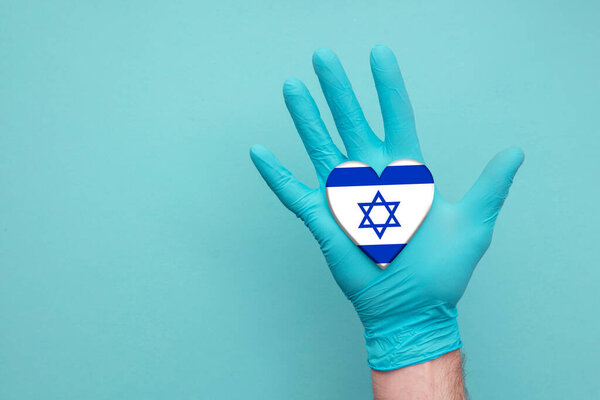 Israel medical health heart. Nurse hand holding country heart flag