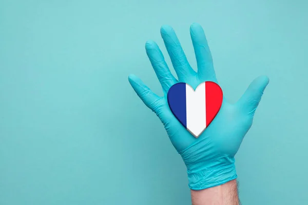 France medical health heart. Nurse hand holding country heart flag