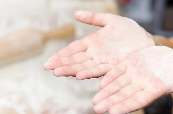 Baking Christmas cookies, child hands cuts dough