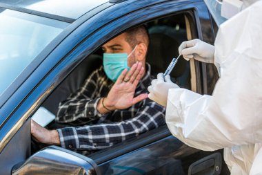 Adam sürüş sırasında COVID 19 testi yapmayı reddediyor. Hastanın burnundan araba camından DNA örneği alıyor. PCR teşhisi koyuyor. Pasaportları var..