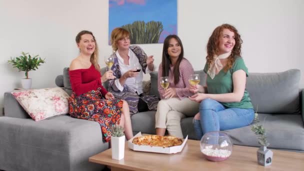 Fyra Leende Kvinnliga Vänner Sitter Soffan Vardagsrummet Medan Skålar Med — Stockvideo
