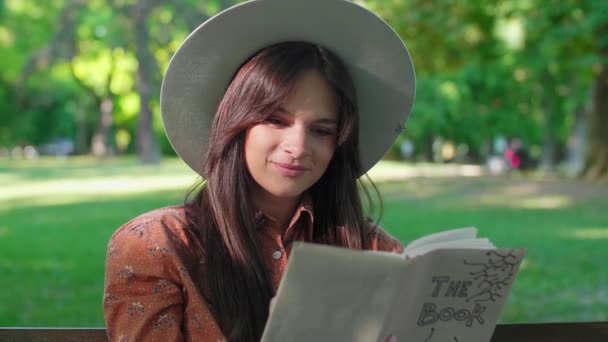 Молода Красива Жінка Капелюхом Сидить Лавці Парку Читаючи Книгу Задньому — стокове відео
