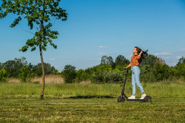 Junge Schöne Mädchen Fährt Auf Einem Elektroroller Durch Den Park — Stockfoto