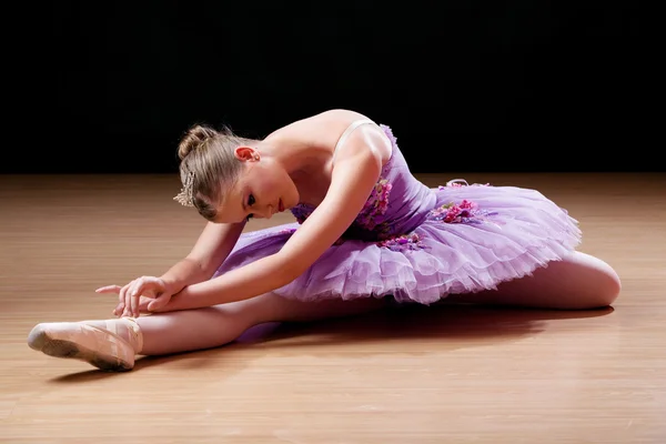 Bailarina adolescente realizando exercícios de alongamento Imagem De Stock