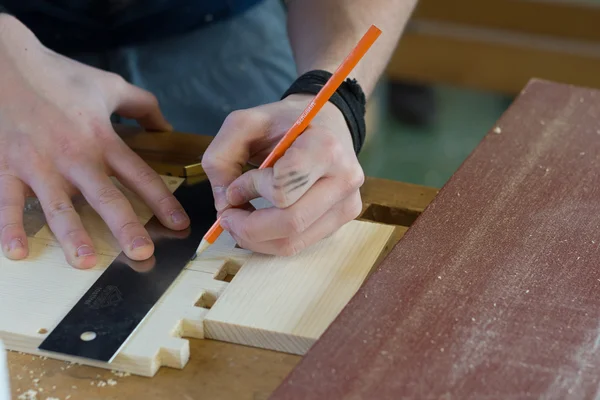 Carpenter working with stop bracket — Stock Photo, Image