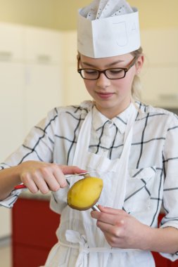 young chef peeling potatoes clipart
