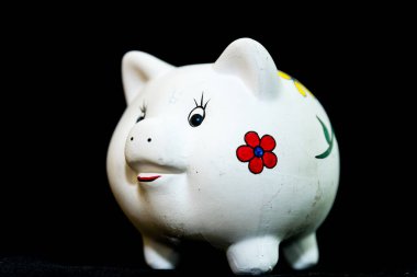 big piggy bank with savings on black background, cut out and copy space