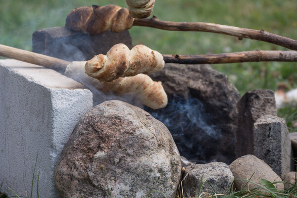 Stock bread is baked at campfire