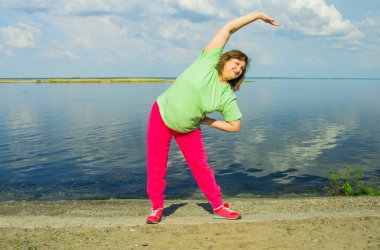 Woman exercise on the river bank