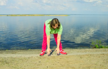 Woman exercise on the river bank