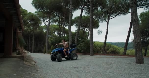 Authentic footage of young beautiful woman driving the quad bike with her son — Stock Video