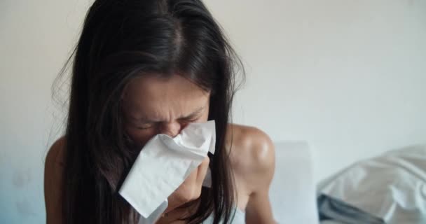 Sickly female blows her nose into a disposable napkin in season of colds — Stock Video