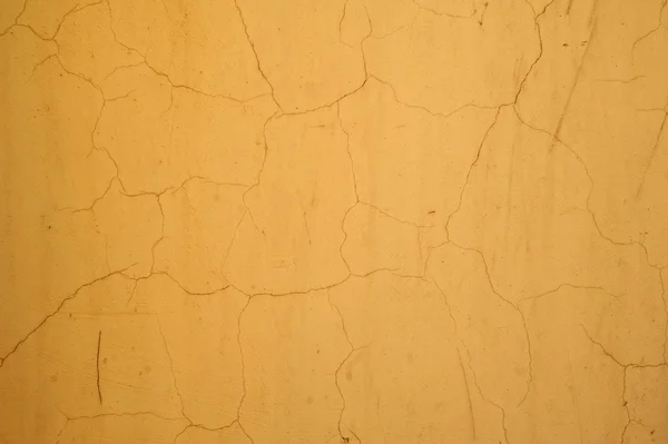 Текстура стены покрыта желтой штукатуркой — стоковое фото