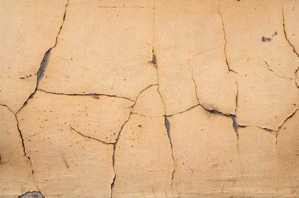 Textuur van muur bedekt gekraakt gips geel — Stockfoto