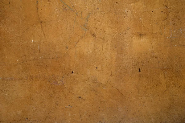 Texture de vieux mur recouvert de stuc jaune — Photo