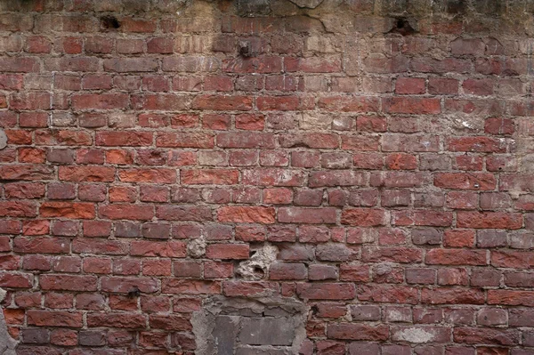 Texture of old red brick wall with traces of plaster — Stock Photo, Image