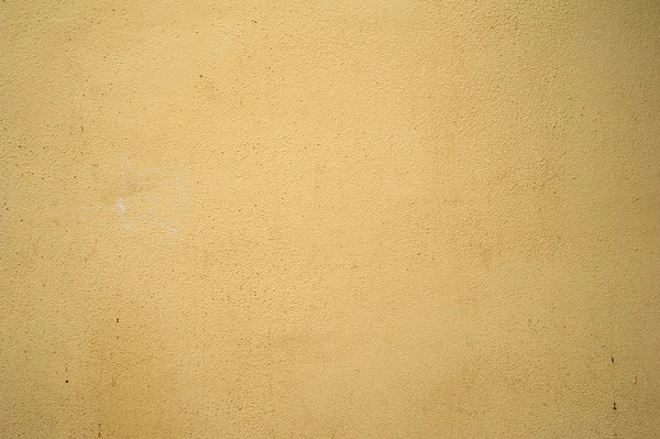 Textuur van oude muur bedekt met gele stucwerk — Stockfoto