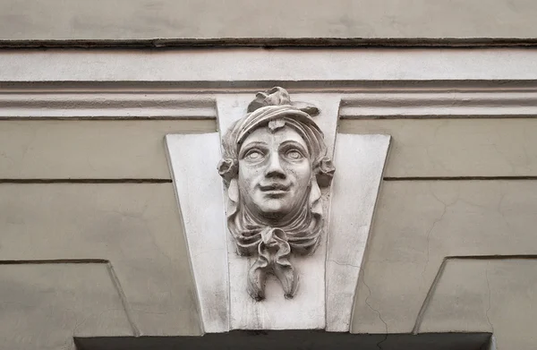 Old bas-relief smiling female head — Stock Photo, Image