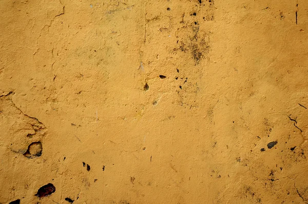 Texture della vecchia parete ricoperta di stucco giallo — Foto Stock