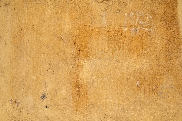 Textura de pared vieja cubierta con estuco amarillo — Foto de Stock