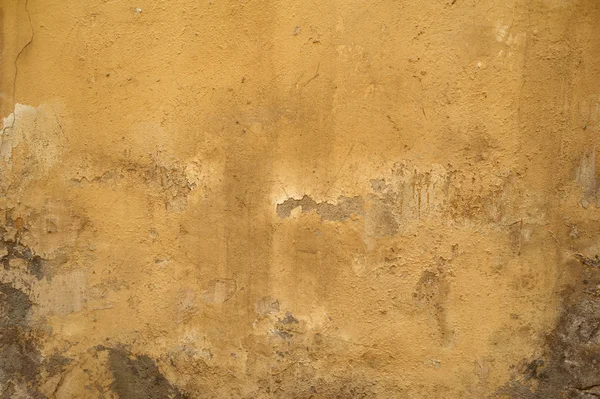 Textur der alten Mauer mit gelbem Stuck überzogen — Stockfoto