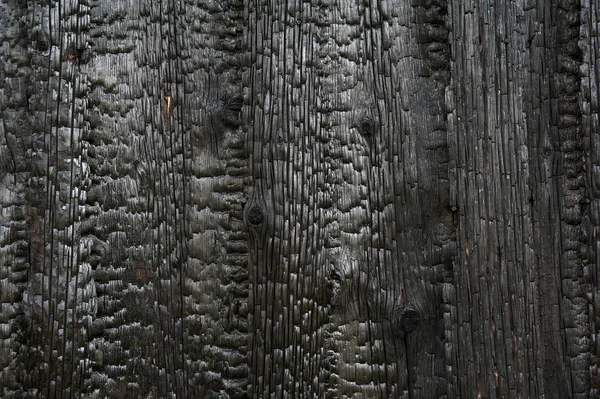 Charred wooden house wall after fire — Stock Photo, Image