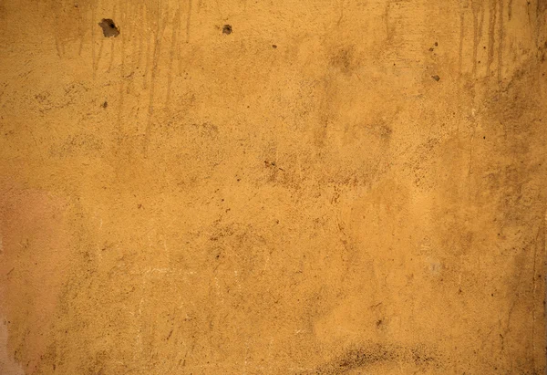 Texture della vecchia parete ricoperta di stucco giallo — Foto Stock