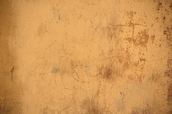 Textury staré zdi pokryté žlutým štuk — Stock fotografie