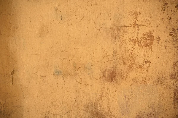 Textur der alten Mauer mit gelbem Stuck überzogen — Stockfoto