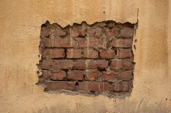 Textuur van oude muur bedekt met gele stucwerk — Stockfoto