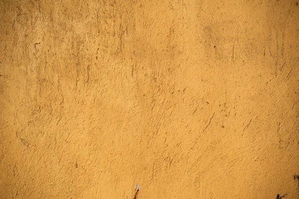 Textur der alten Mauer mit gelbem Stuck überzogen — Stockfoto