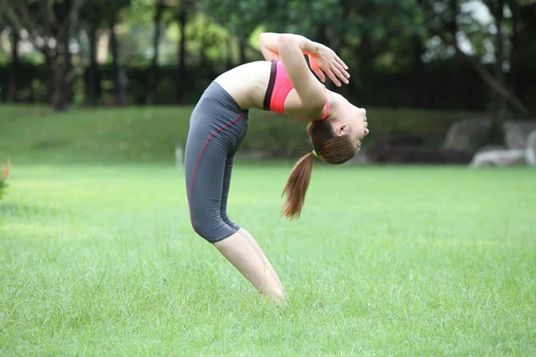 Young woman practicing yoga - Urdhva Dhanurasana , Upward bow po