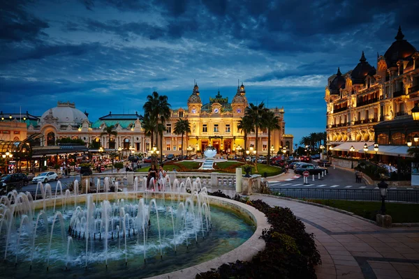 Monaco, Monte-Carlo, 04.09.2015: Casino Monte-Carlo in the night, hotel de Paris, night illumination, luxury cars, players, tourists, fountain, cafe de paris, long exposure, summer