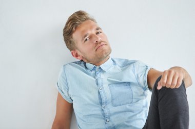 Acımasız adam yumruklarını sıktı, sandalyede oturan kısa kollu gömlekli hafifçe, diz, dalgın eğildi alın, bakışları altında eğildi