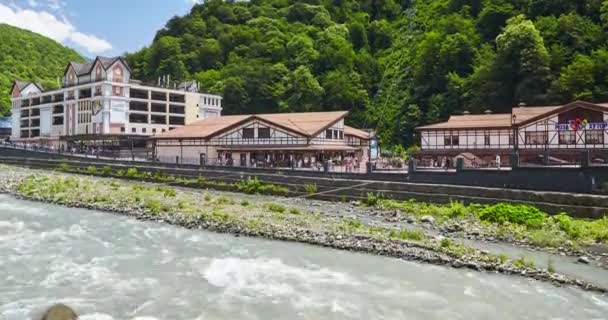 Rusia, Sochi, 21 de junio de 2016: El lapso de tiempo con efecto zoom de la estación de esquí alpino Rosa Khutor a la hora de verano, Krasnaya Polyana, cielo azul, teleférico, telesilla, árboles verdes, río Mzymta, región de Krasnodarskiy, mostradores de efectivo, valle de Rose — Vídeo de stock