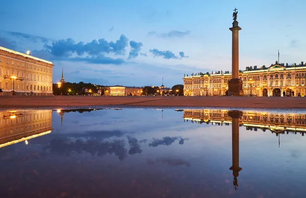 ロシア、サンクトペテルブルク、2016 年 7 月 3 日: 宮殿広場にはイルミネーション、冬宮殿、エルミタージュ美術館、アレクサンダー ・ コラム、雨、多くの観光客、日没後水プールの反射水ミラー — ストック写真