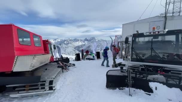 Rusko, Kabardino-Balkán, 07 Leden 2021: DJ hraje na vrcholu Mount Elbrus, snowboardisté tančí, hora na pozadí, lyžařské středisko Azaus — Stock video