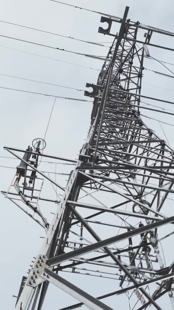 Huge Metal high-voltage tower with electric wires, the bottom view up, slow movement of a video camera, cloudy weather — Stock Video