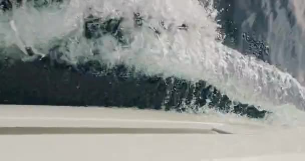 Raging stream of sea water from under boat at sunny weather, slow motion, vacation, happy time, azure water, nobody — Video