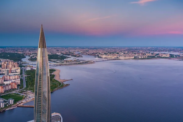 Russia, St.Petersburg, 16 May 2021: Drone point of view of highest skyscraper in Europe Lakhta Center at pink sunset, Headquarters of the oil company Gazprom, stadium Gazprom Arena on background — Stock Photo, Image