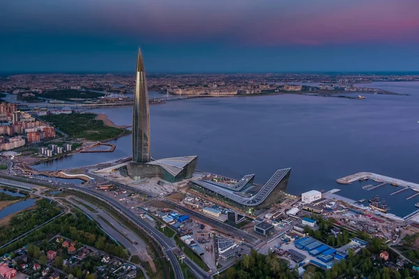 Russia, St.Petersburg, 16 травня 2021: Drone point of view of high skyscraper in Europe Lakhta Center at pink sunset, Headquarters of the oil company Gazprom, Stadium Gazprom Arena on background Стокове Фото