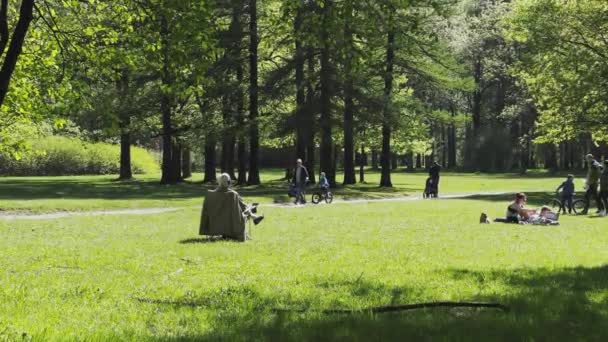 러시아, 상트페테르부르크, 2021 년 5 월 22 일: 노인 연금 생활자 가 여름 정원에 있는 부드러운 의자에 앉아 있다. — 비디오