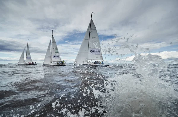 Russia, St. Petersburg, 23 July 2021: Competition of sailboats in regatta at storm weather, race, big waves, sail regatta, cloudy weather, main sail, jib, team work, splashes — Stock Photo, Image