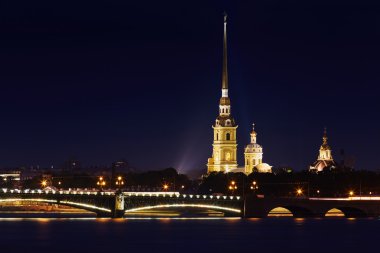 Russia, St. Petersburg, 06.20.2015: Peter and Paul Fortress, highlighted Trinity Bridge, the river Neva, night landscape, illuminated sights of St. Petersburg, the steeple with a cross, dome, sky, warm summer day clipart