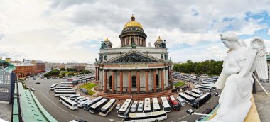Russia, St. Petersburg, Isaac's Cathedral, 07.14.2015: A view of Isaac's Cathedral from 5 floors of the hotel 4 season, around the cathedral are many tour buses and tourists, a lot of people walking upstairs colonnade, sunny, white cloud