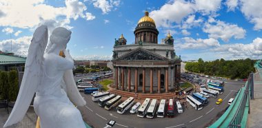 Russia, St. Petersburg, Isaac's Cathedral, 07.14.2015: A view of Isaac's Cathedral from 5 floors of the hotel 4 season, around the cathedral are many tour buses and tourists, a lot of people walking upstairs colonnade, sunny, white cloud