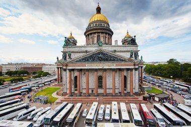 Russia, St. Petersburg, Isaac's Cathedral, 07.14.2015: A view of Isaac's Cathedral from 5 floors of the hotel 4 season, around the cathedral are many tour buses and tourists, a lot of people walking upstairs colonnade, sunny, white cloud