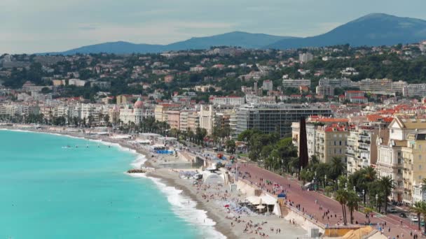 FRANCE, NICE, 12.09.2015: Promenade des Anglais, Hotel Negresco at sunset, walking tourists, azure coast, cafe on the beach, people sunbathing — Stock Video