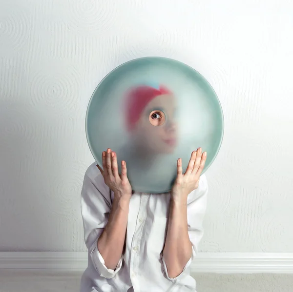 Girl looking through a glass lens — Stock Photo, Image
