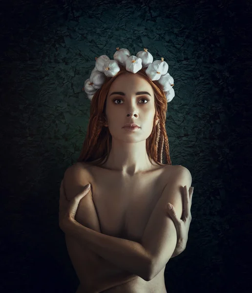 Portrait of a vampire with a wreath of garlic on a blue backgrou — Stock Photo, Image